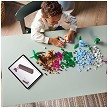 Lifestyle view highlighting the manual building and assembly process of the LEGO® Classic 11041 Creative Dinosaurs model. 