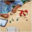 Lifestyle view highlighting the manual building and assembly process of the LEGO<sup>®</sup> Creator 31379 Fierce Dinosaur model. 