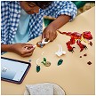 Lifestyle view highlighting the manual building and assembly process of the LEGO<sup>®</sup> Creator 31379 Fierce Dinosaur model. 
