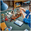 Lifestyle view highlighting the manual building and assembly process of the LEGO<sup>®</sup> Creator 31387 Iconic Pirate Ship model. 