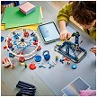 Lifestyle view highlighting the manual building and assembly process of the LEGO<sup>®</sup> Creator 31389 Iconic Ferris Wheel model. 