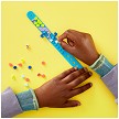 Lifestyle view highlighting the manual building and assembly process of the LEGO DOTS 41801 My Pets Bracelet SOLD OUT model. 