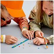 Lifestyle view highlighting the manual building and assembly process of the LEGO® DOTS 41918 Adventure Bracelets model. 