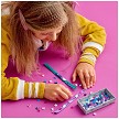 Lifestyle view highlighting the manual building and assembly process of the LEGO® DOTS 41921 Extra DOTS - Series 3 model. 
