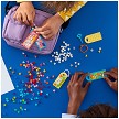 Lifestyle view highlighting the manual building and assembly process of the LEGO® DOTS 41949 Bag Tags Mega Pack - Messaging (SOLD OUT) model. 